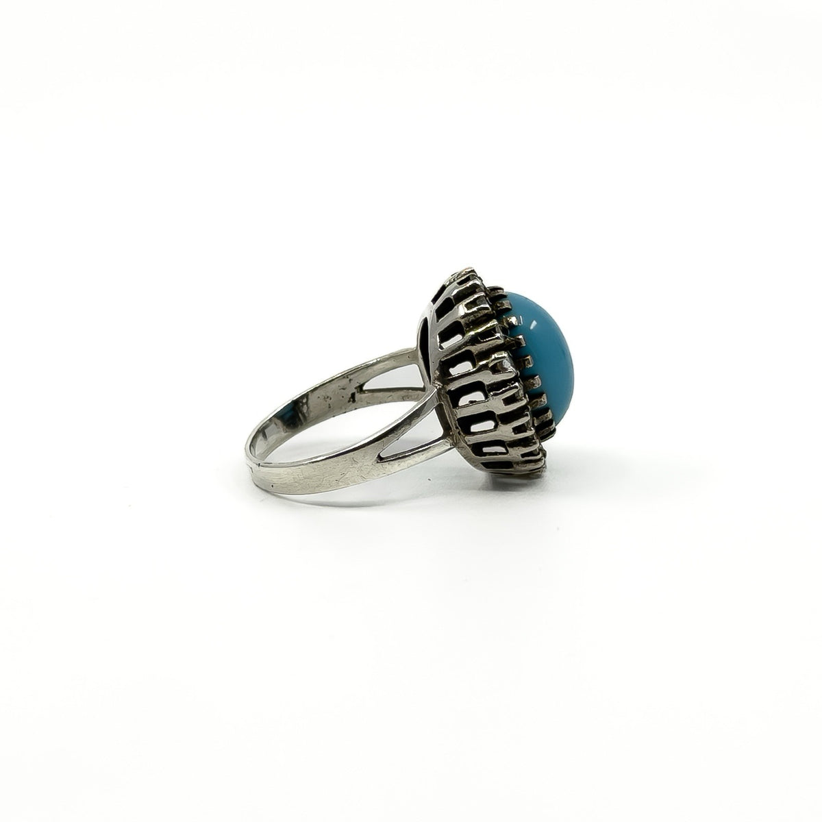Side profile showing the raised turquoise and diamond halo ring setting