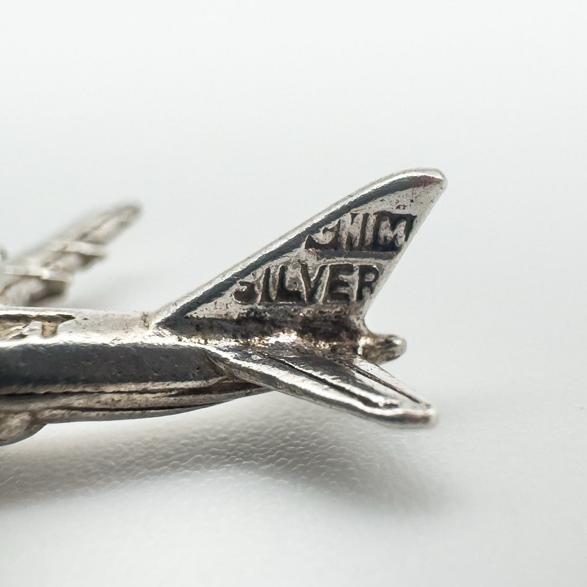 Close-up of aircraft tail showing 'SILVER' stamp and detailing on the rudder
