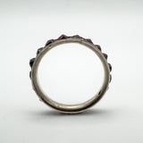 Side view through the ring showing height and garnet protrusion above the band