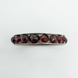Close-up top view of vintage Bohemian garnet eternity ring in sterling silver