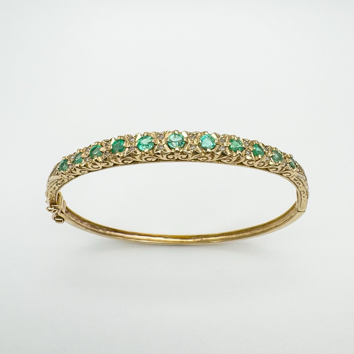 9ct gold bangle with natural emeralds and diamonds in claw setting