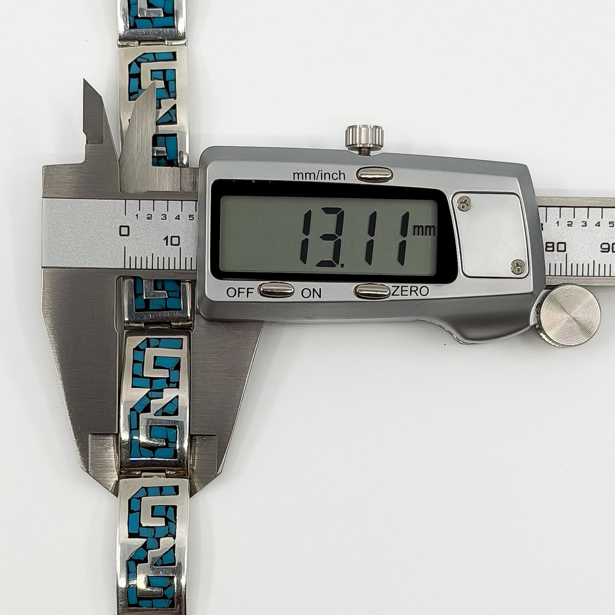 Digital caliper showing the sterling silver turquoise panel bracelet measuring approximately 13.1mm wide