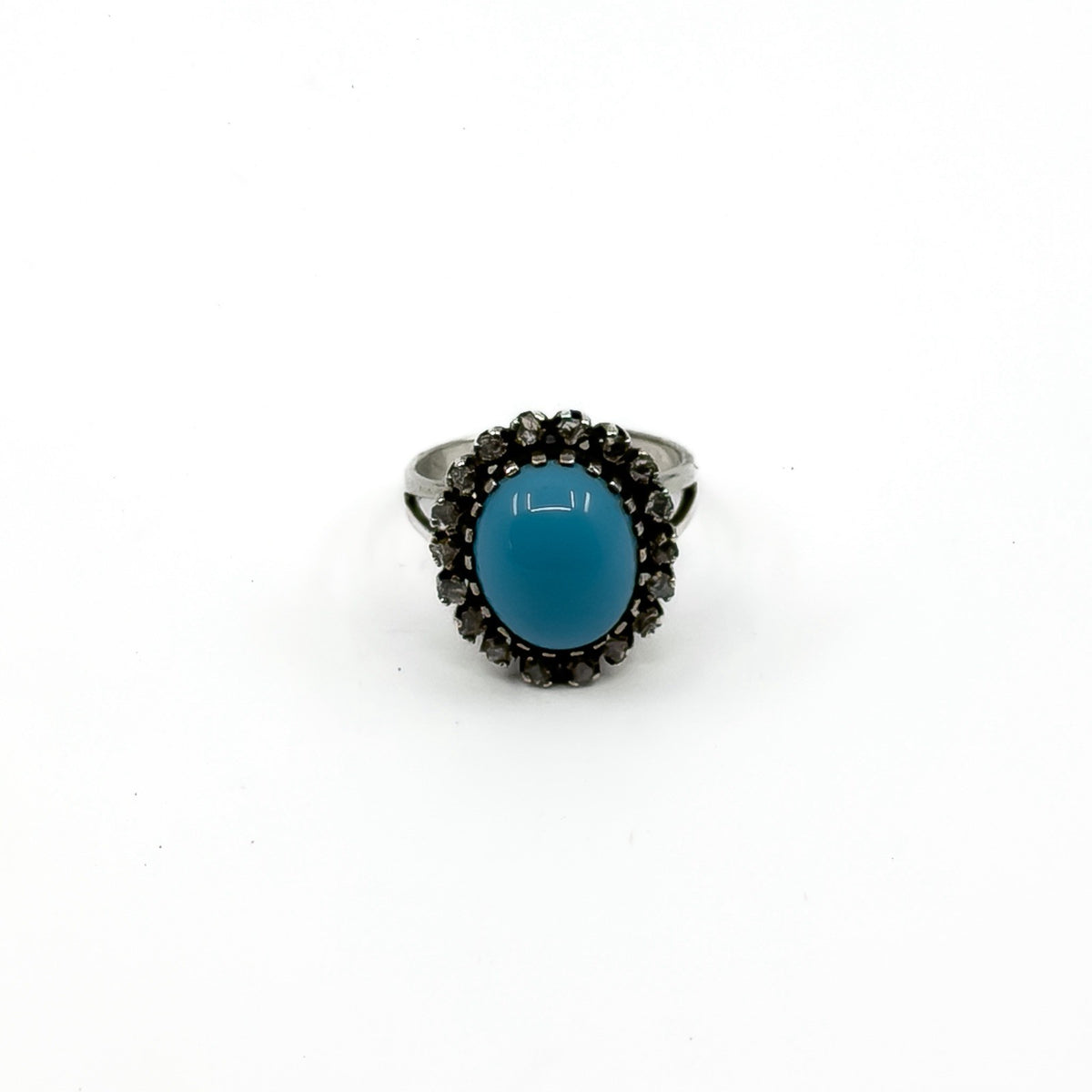 Upright view showing the high turquoise and diamond halo ring setting
