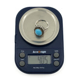 Sterling silver turquoise diamond halo ring on digital scales showing approximately 4g