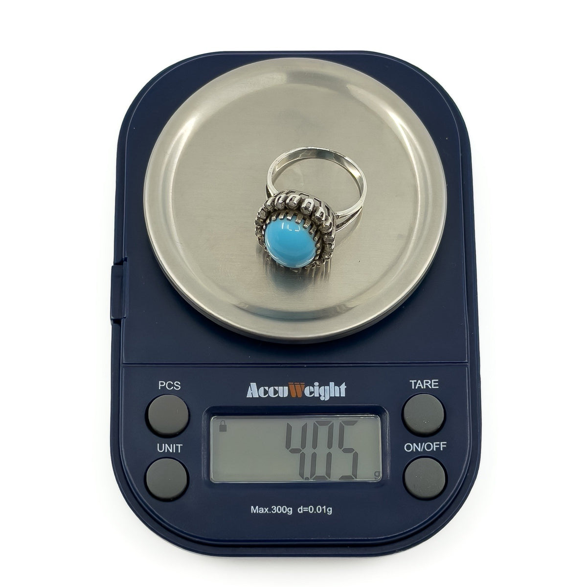 Sterling silver turquoise diamond halo ring on digital scales showing approximately 4g