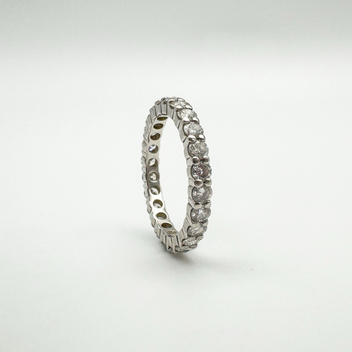 Upright platinum eternity ring with prong-set natural diamonds