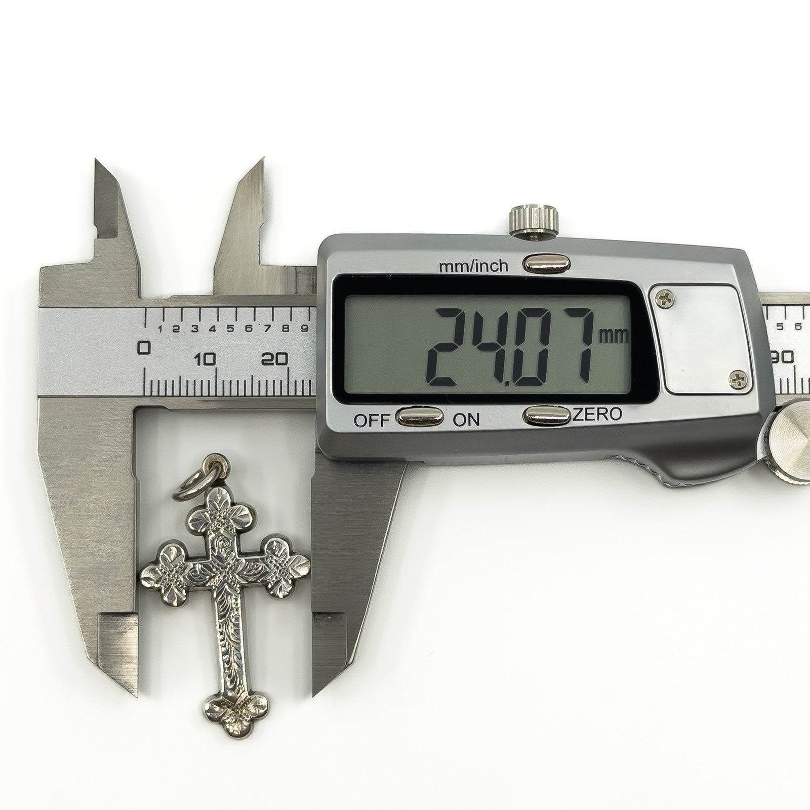 Antique Victorian silver cross pendant measured at approximately 24mm wide with digital calipers