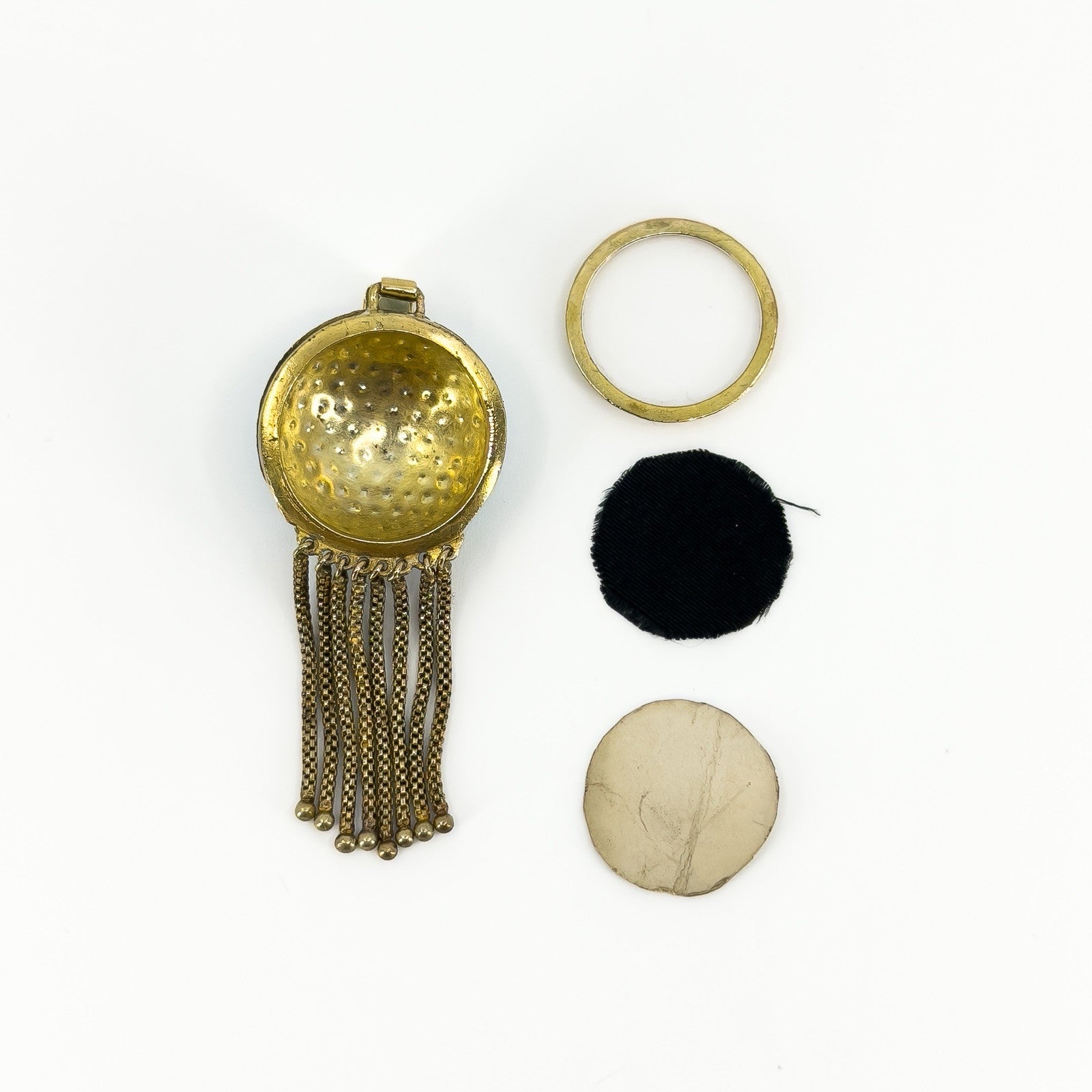 Reverse of Victorian tassel locket with removable frame, fabric insert and backing plate shown separately.