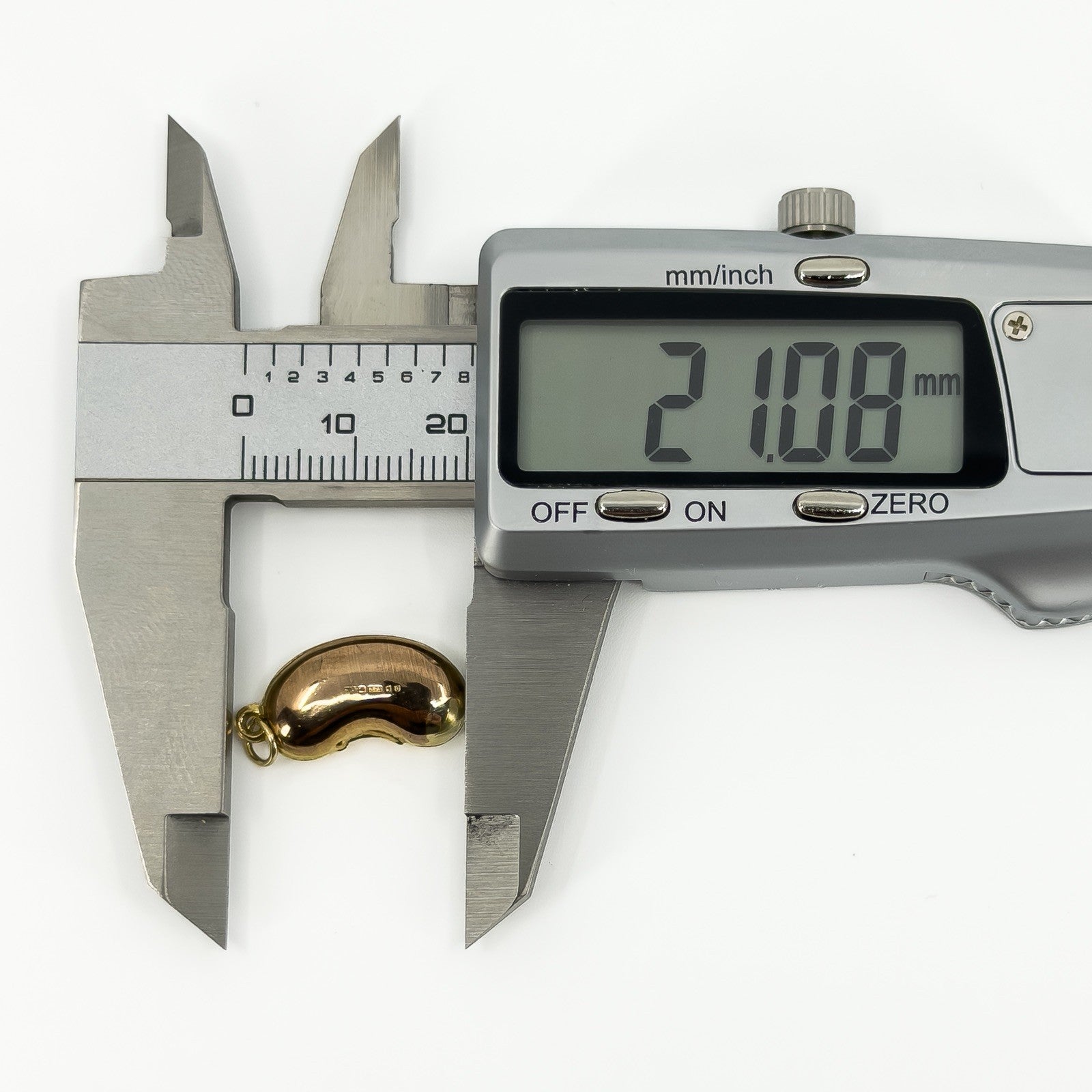 Vintage 9ct gold lucky bean charm pendant measured at approximately 21mm long with digital calipers.