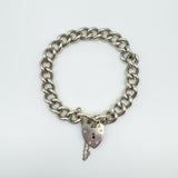 Vintage sterling silver curb bracelet with heart padlock clasp and safety chain, closed loop
