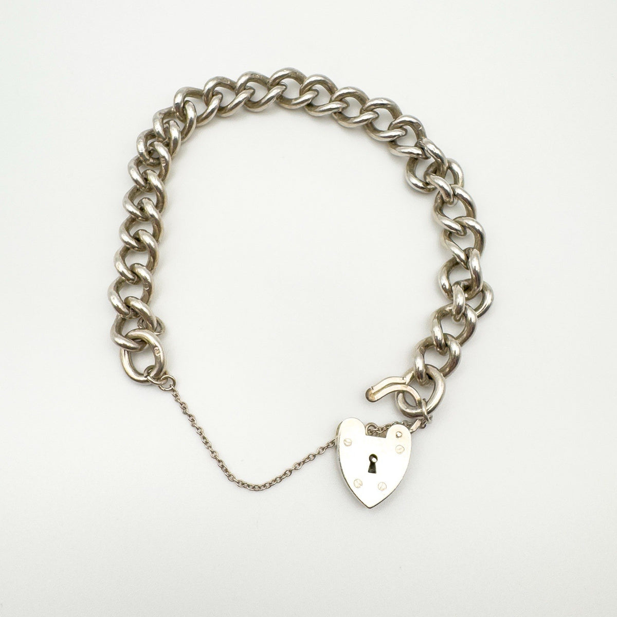 Sterling silver bracelet with open heart padlock clasp and safety chain fully extended