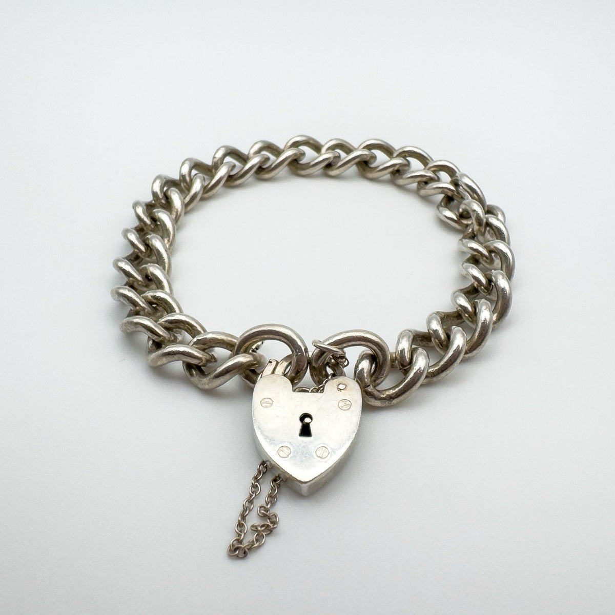 Vintage silver charm bracelet with working heart padlock and heavy curb links