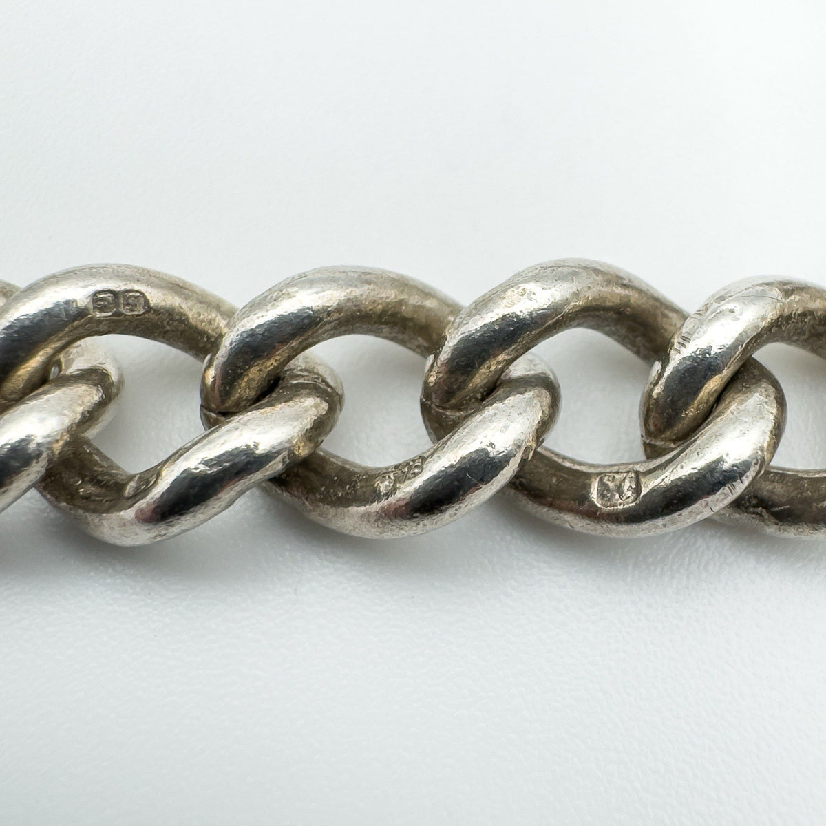 Close-up of sterling silver curb links showing 925 hallmarks