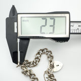 Caliper measuring link width of vintage silver bracelet at 2.3mm