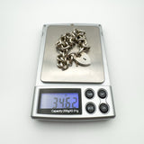 Vintage sterling silver bracelet on digital scale showing weight of 34.62g