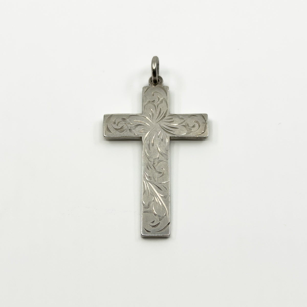 Vintage sterling silver cross pendant with engraved foliate detail and a plain bail.
