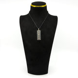 Vintage sterling silver ingot pendant on a black display bust, showing the front hallmark design.