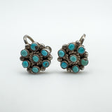 Close-up of vintage sterling silver screw back earrings with turquoise cabochons
