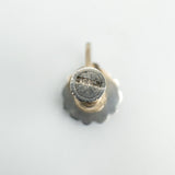 Back view of screw back earrings showcasing hallmark and fastening