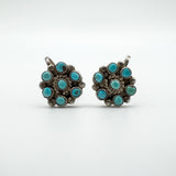 Earrings presented on a neutral background emphasizing turquoise color