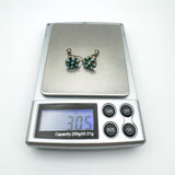 Turquoise screw back earrings on digital scale showing weight of 3.05 grams
