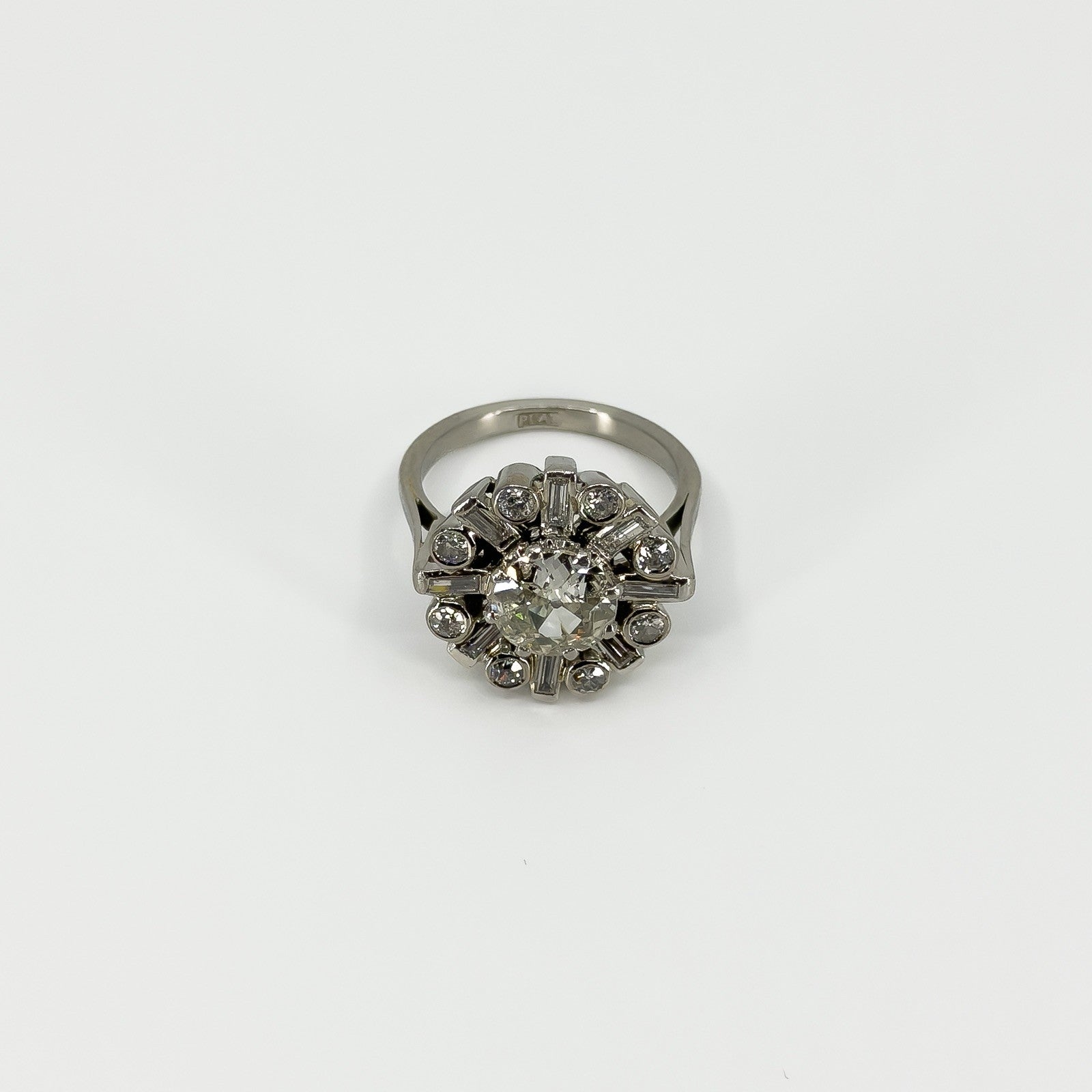 Front view of vintage platinum 2.70ct diamond cluster ring with old cut centre and geometric surround.