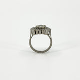 Rear profile of vintage platinum diamond cluster ring showing the raised setting and plain band.