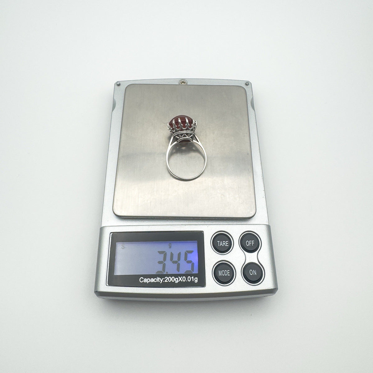 Digital scale showing weight of sterling silver carnelian ring as 3.4g