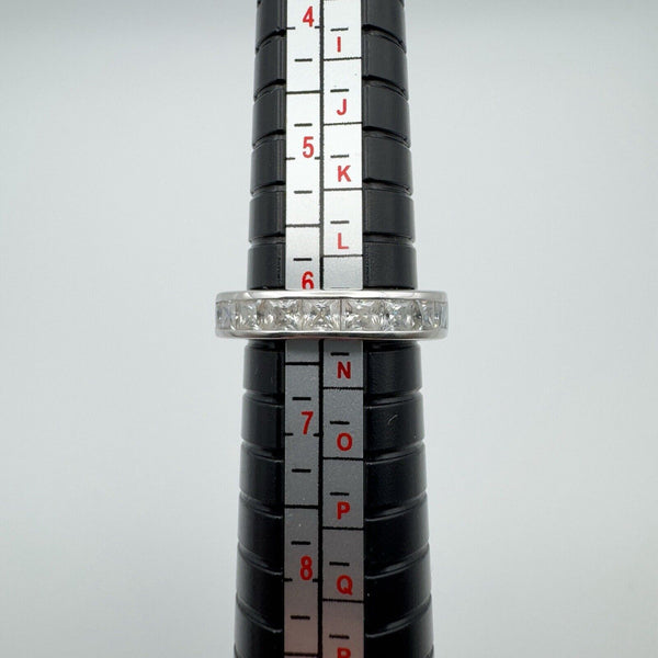 A 0.90ct Moissanite princess-cut channel set band in sterling silver 925, displayed on a ring mandrel, showing size N-O