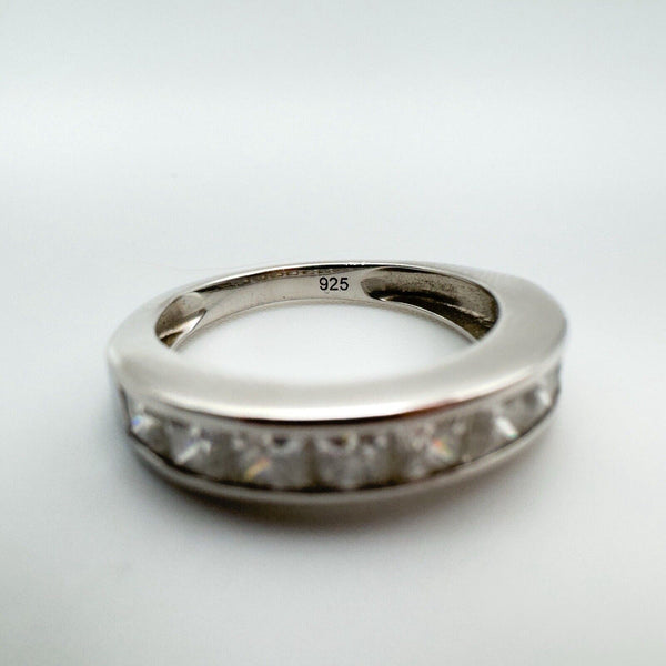 Close-up of a 0.90ct Moissanite princess-cut channel set band in sterling silver 925, showcasing the "925" hallmark.