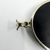 Close up of the 14k stamp on the white gold bail of the black onyx and diamond bow pendant.
