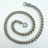 18 inch sterling silver curb chain with bolt ring clasp, photographed coiled on white background.