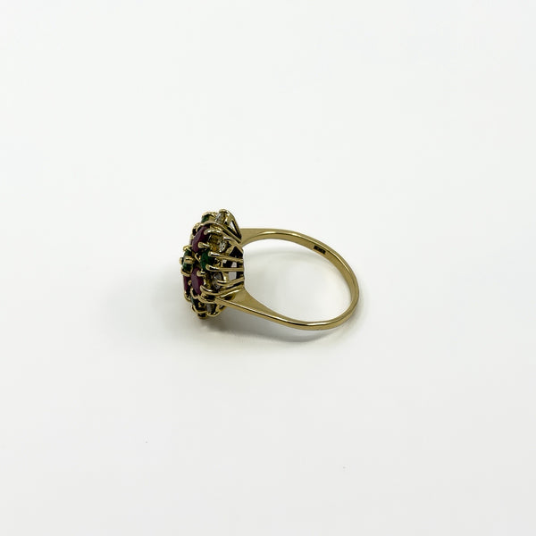 Side view of vintage 18ct gold ruby emerald and diamond cluster ring with raised open gallery setting