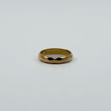 Vintage 18ct rose gold faceted band ring laid flat, showing the polished full band design.