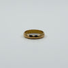 Vintage 18ct rose gold faceted band ring laid flat, showing the polished full band design.