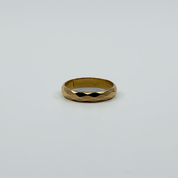 Vintage 18ct rose gold faceted band ring laid flat, showing the polished full band design.