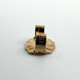 Close up of a 9ct gold butterfly back stamped 375 for the cultured black pearl stud earrings