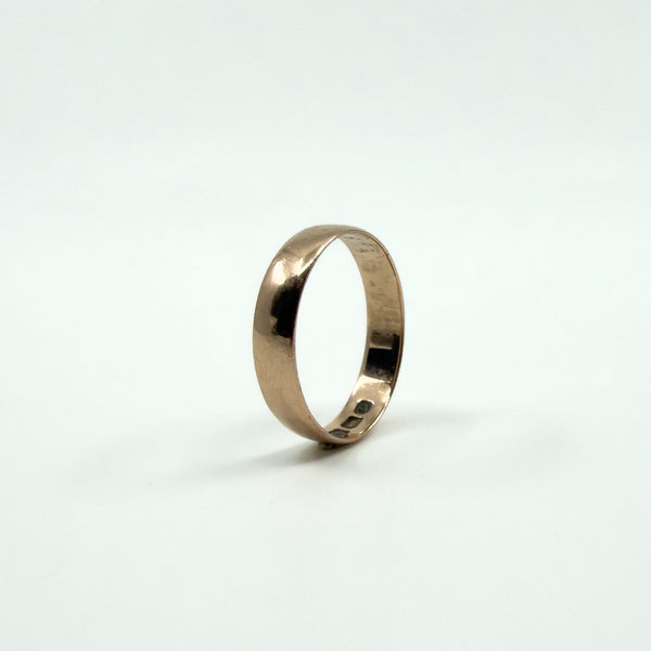 Standing view highlighting the shape and proportions of a Victorian rose gold band ring.