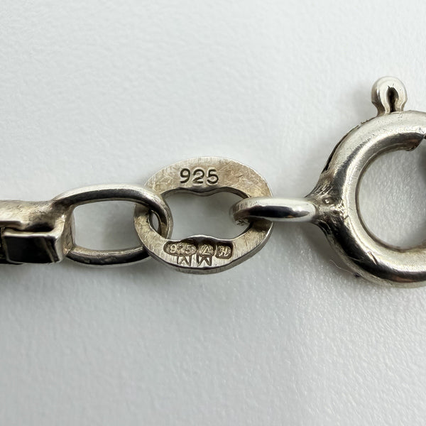 Close-up of the 925 stamp and import marks on a vintage sterling silver box chain necklace.
