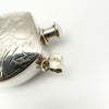 Close-up of 925 sterling silver stamp on vintage perfume bottle pendant