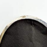 Close up of the 925 stamp inside the vintage sterling silver oval locket rim