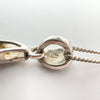 Close-up of 925 hallmark on sterling silver pendant bail