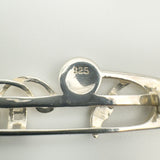 Close-up of 925 stamp on vintage sterling silver Celtic brooch