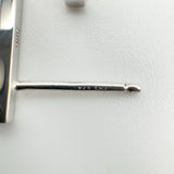 Close-up of earring post stamped 925 with infinity-style maker’s mark on sterling silver J earrings