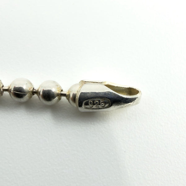 Close-up showing the 925 mark on the sterling silver ball chain end fitting.