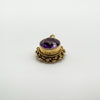 Vintage gold pendant showing hallmark and amethyst in raised bezel setting