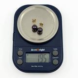 Scale showing vintage 9ct gold cultured black pearl stud earrings weighing approximately 1.95g together
