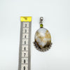 Front view of chunky agate pendant beside ruler measuring approx 61mm length