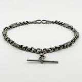 Angled view of an antique Victorian sterling silver Albert chain with faceted links and pierced bar sections