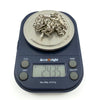 Antique sterling silver Albert chain shown on scales with weight reading approximately 24.35g.
